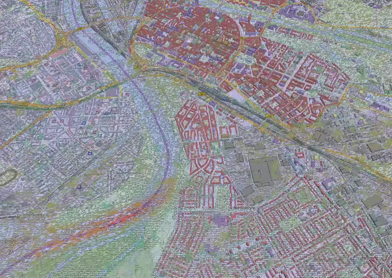 Die Innenstadt von Mannheim in der Starkwindanalyse bei Sturm: Über der Karte ziehen Partikel mit der Strömung durch Straßen und über Plätze; ihre Farbe zeigt die Windgeschwindigkeit.